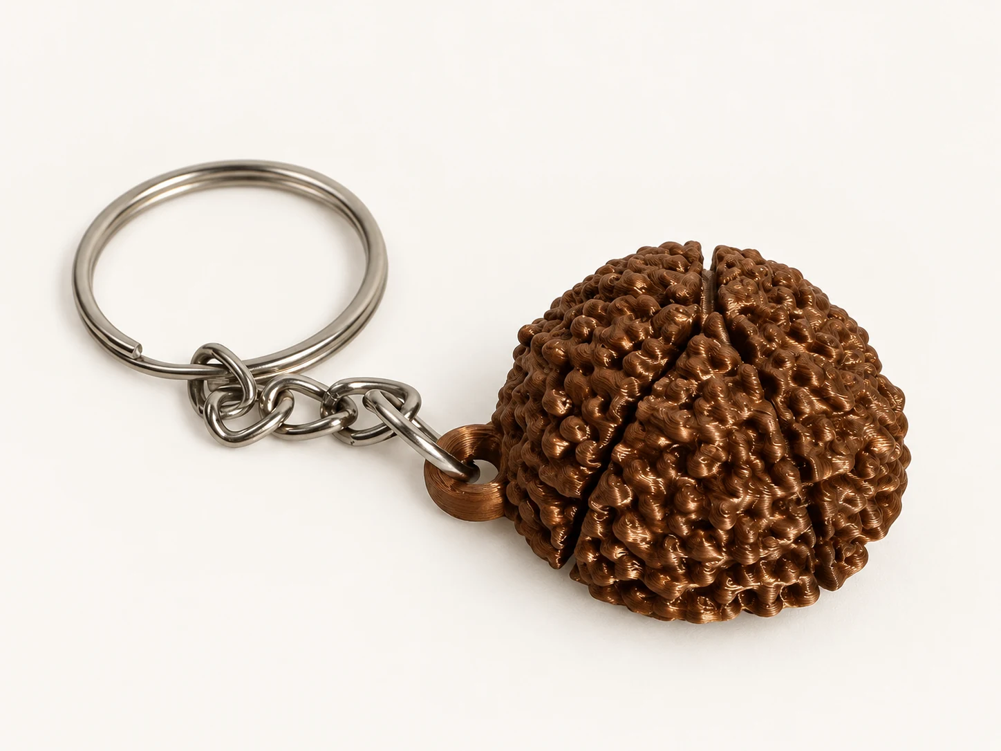 Textured Shiny Brown Panchmukhi Rudrakshi keychain with its silver chain and metal key ring